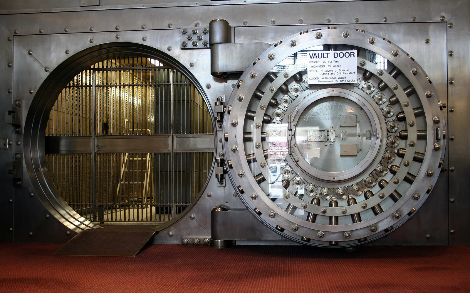 The circular steel door of a savings bank vault standing open