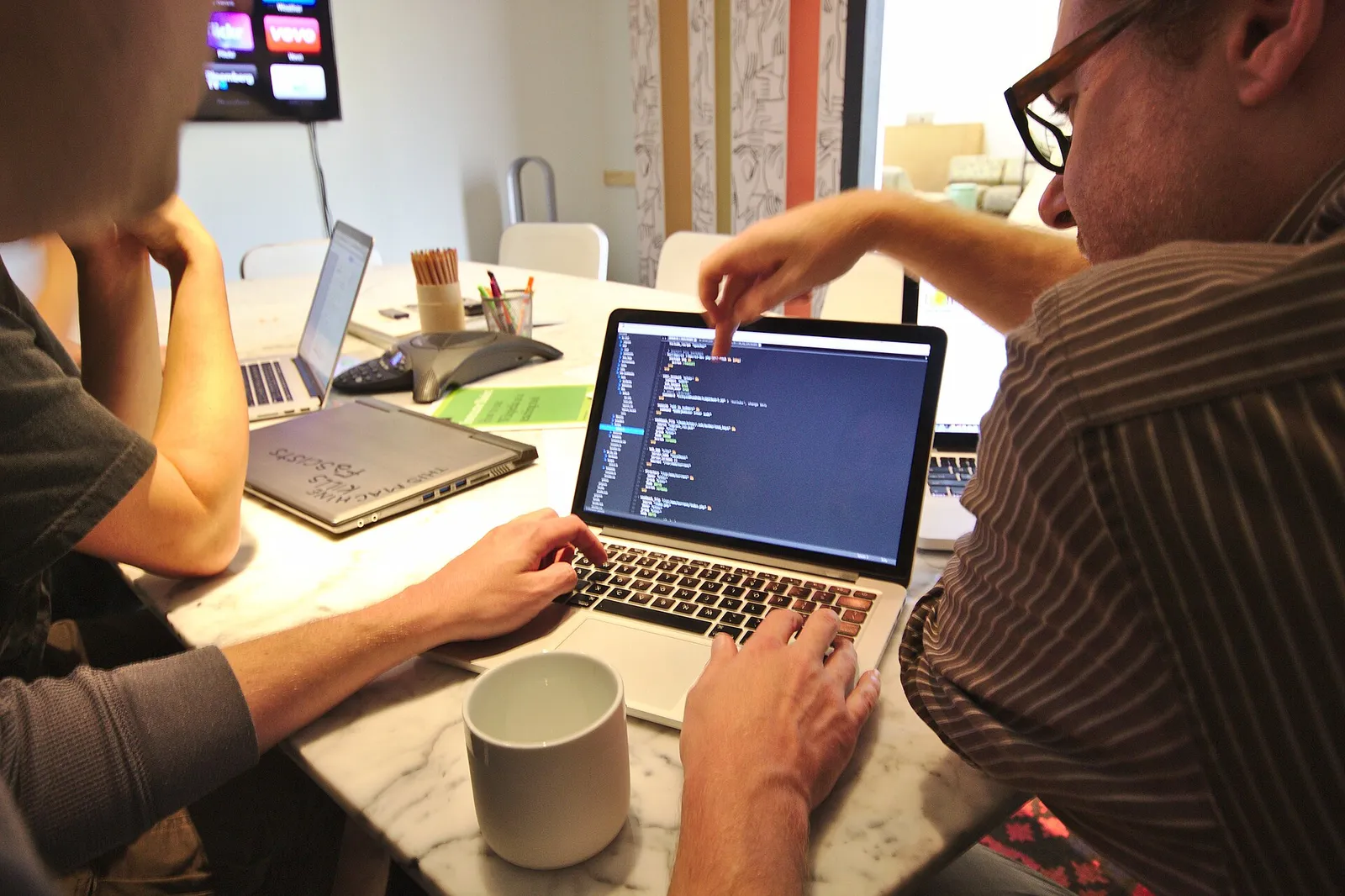 People discussing technology in an office