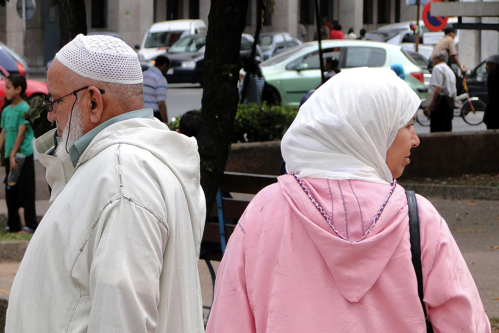 An elderly couple sitting together in a park