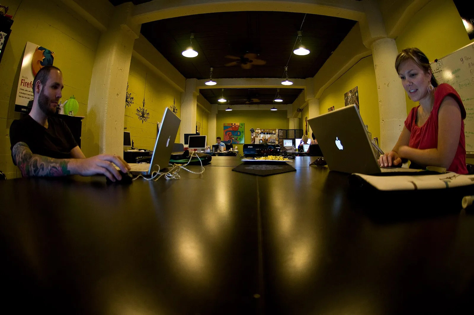 People working at desks in a shared office space