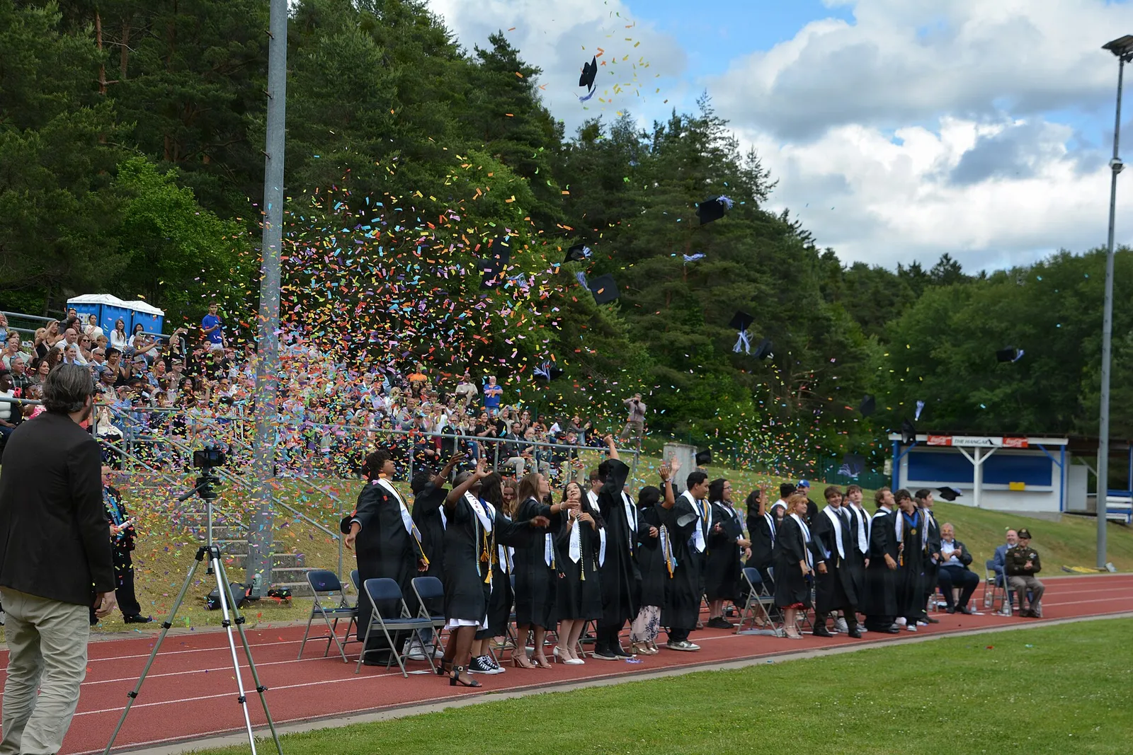 Graduates throw their caps at a commencement ceremony