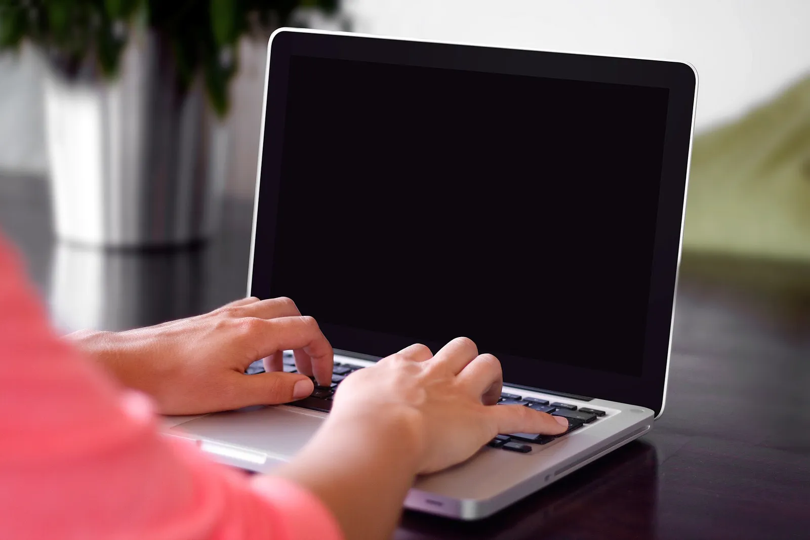 A person typing on a laptop