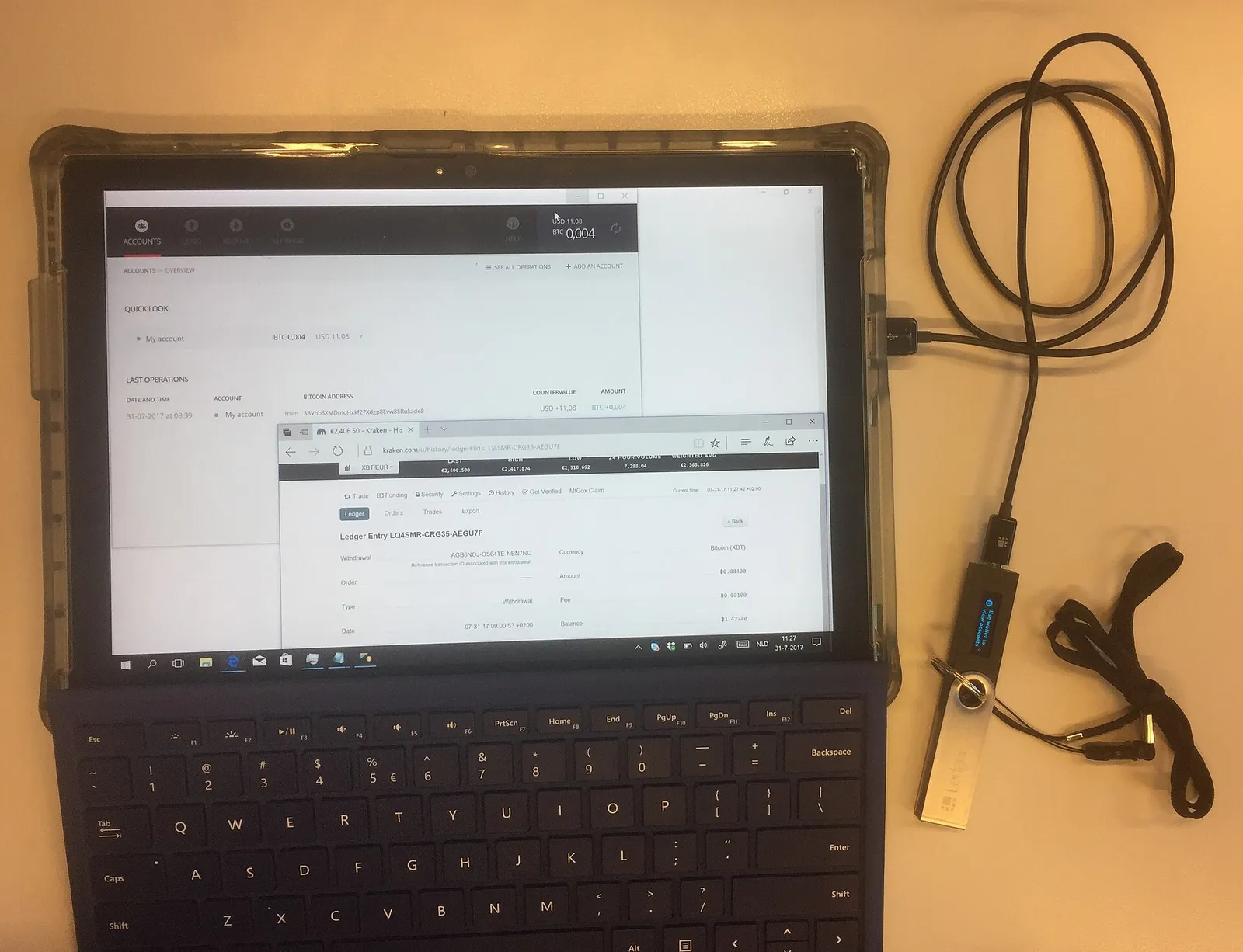 A hardware crypto wallet connected to a laptop