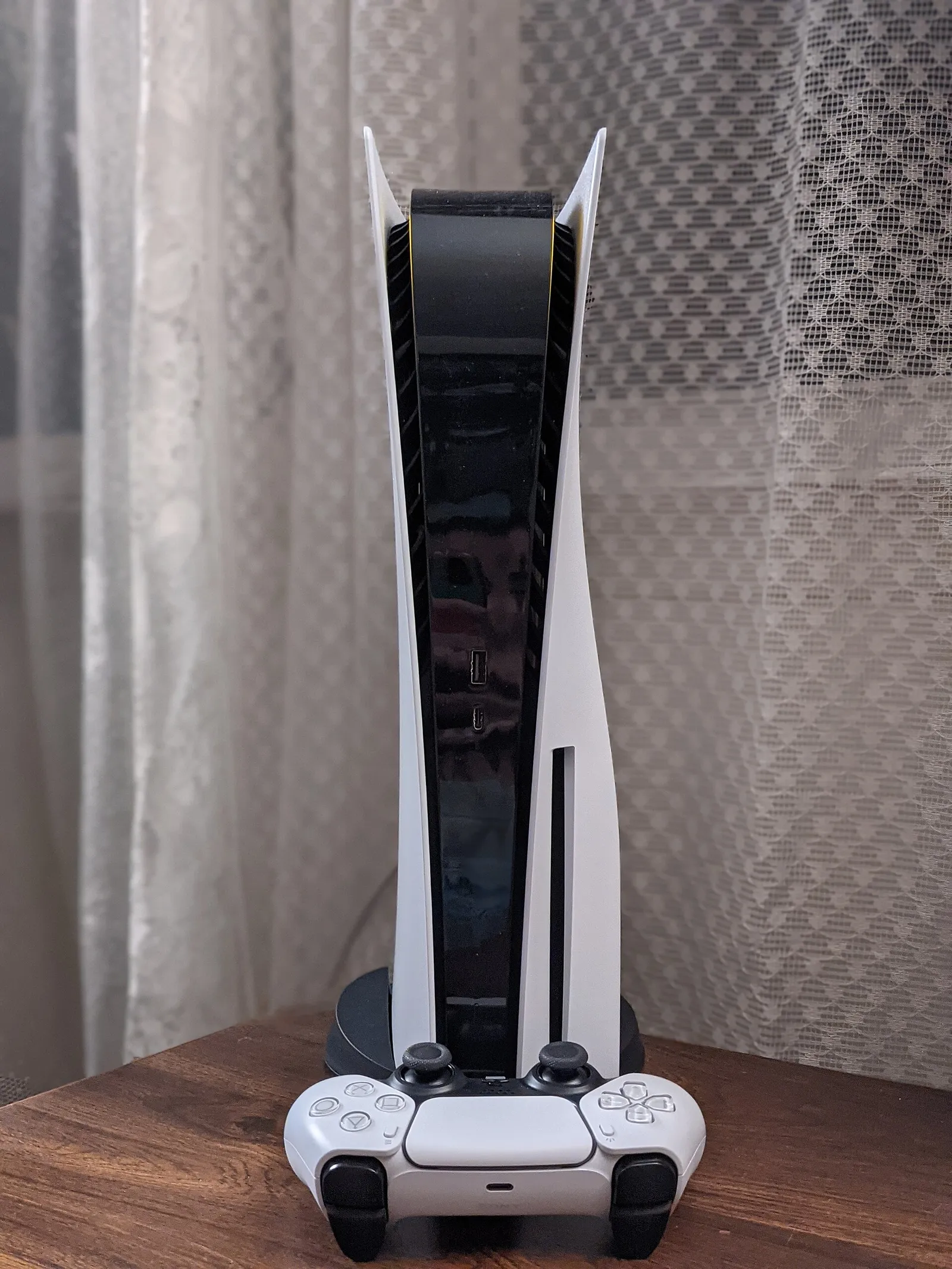 A PlayStation 5 console and DualSense controller