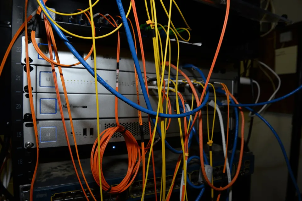A server rack filled with networking cables and equipment