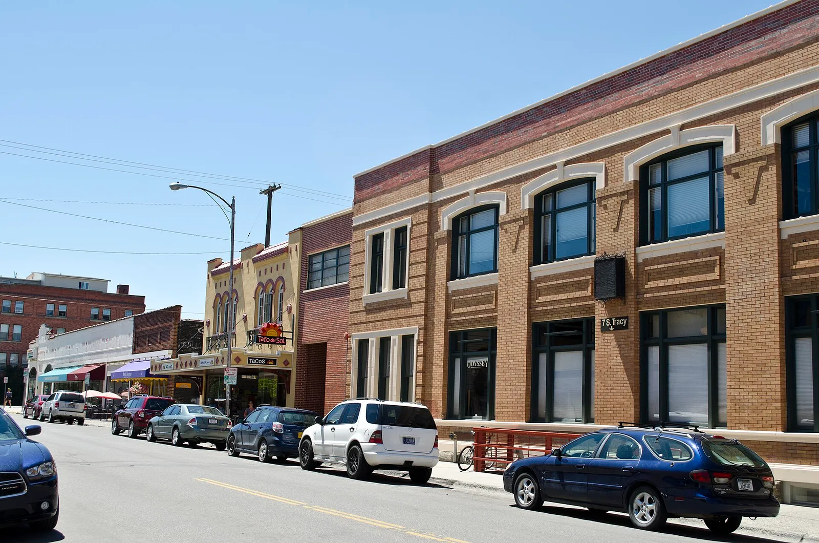 Shops and parked cars on South Tracy Avenue in downtown Bozeman, Montana