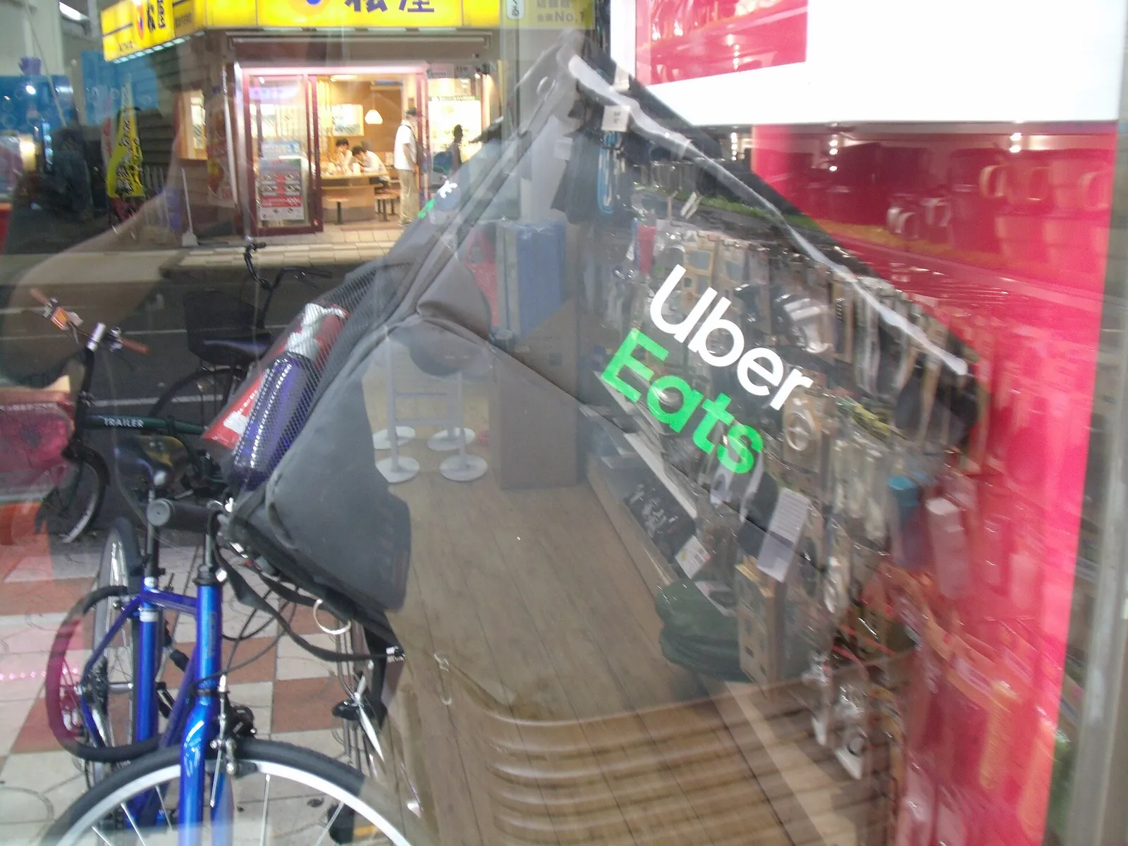 An Uber Eats delivery bag on a courier