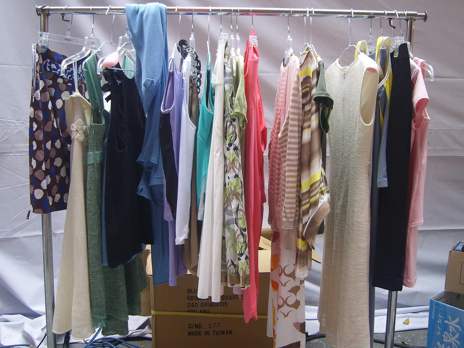 Rows of garments hanging on clothes racks at a fashion event