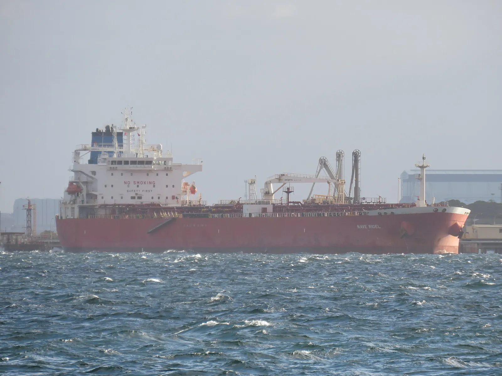 A crude oil tanker moored at a refinery jetty