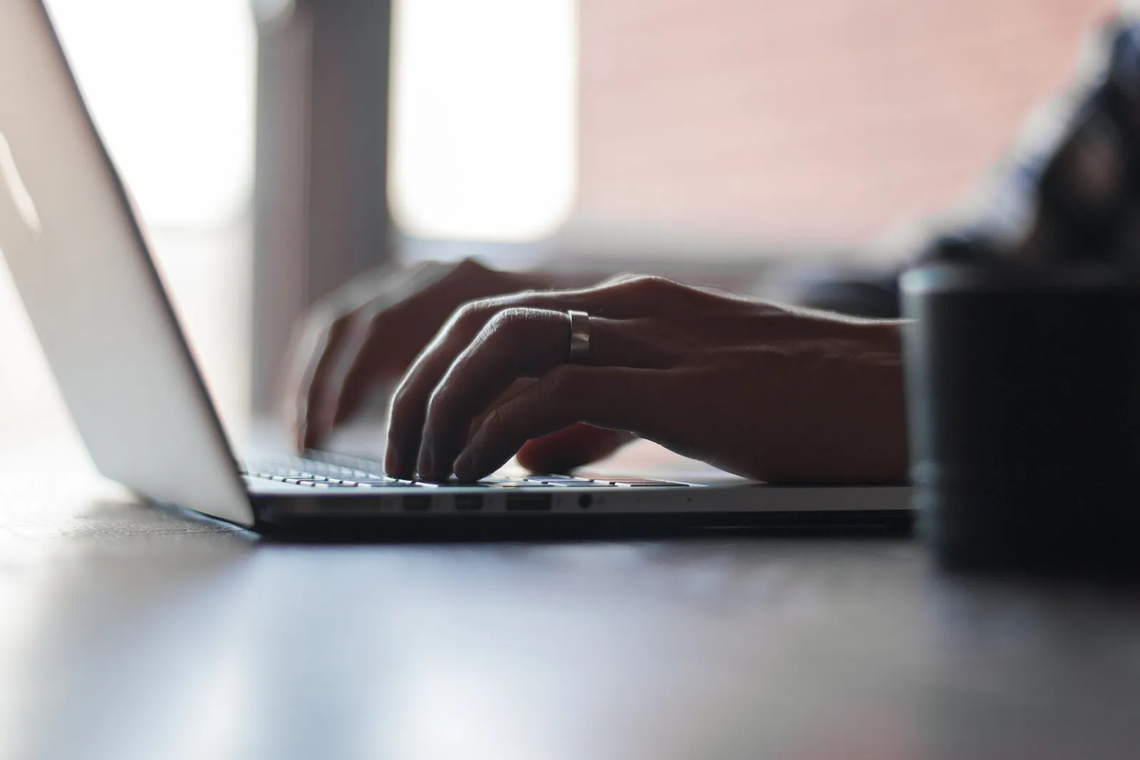 A person typing on a laptop