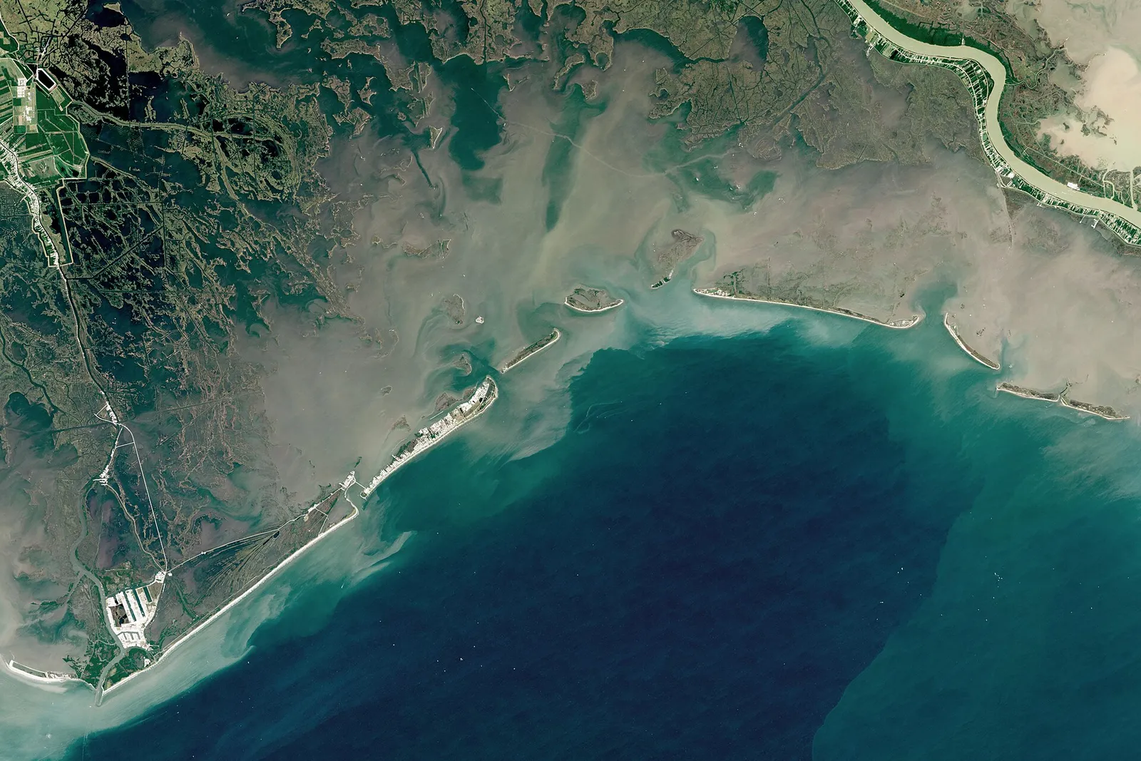 A satellite view of the Louisiana coastline showing marsh, water and river channels
