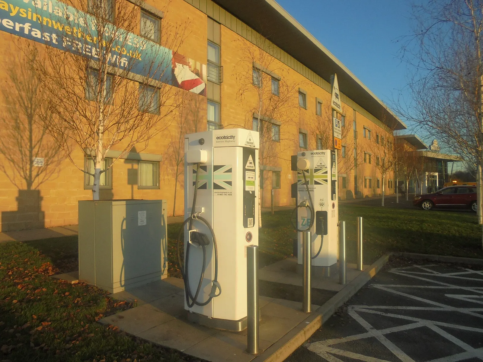 An electric car charging at a service station