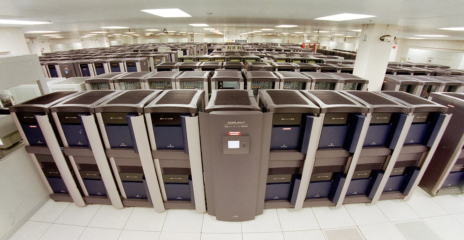 Rows of supercomputer cabinets in a laboratory machine hall