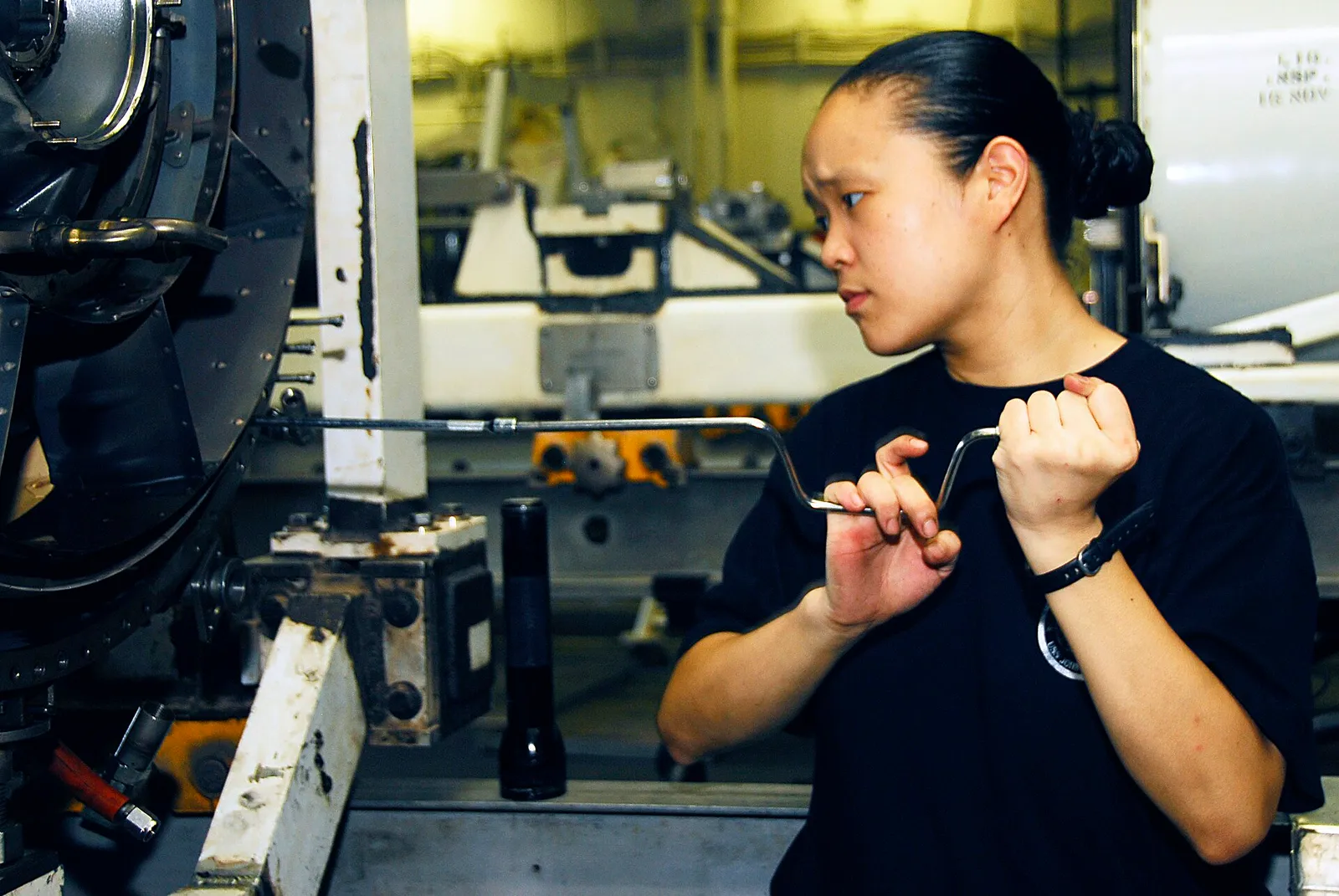 A technician working on an aircraft jet engine