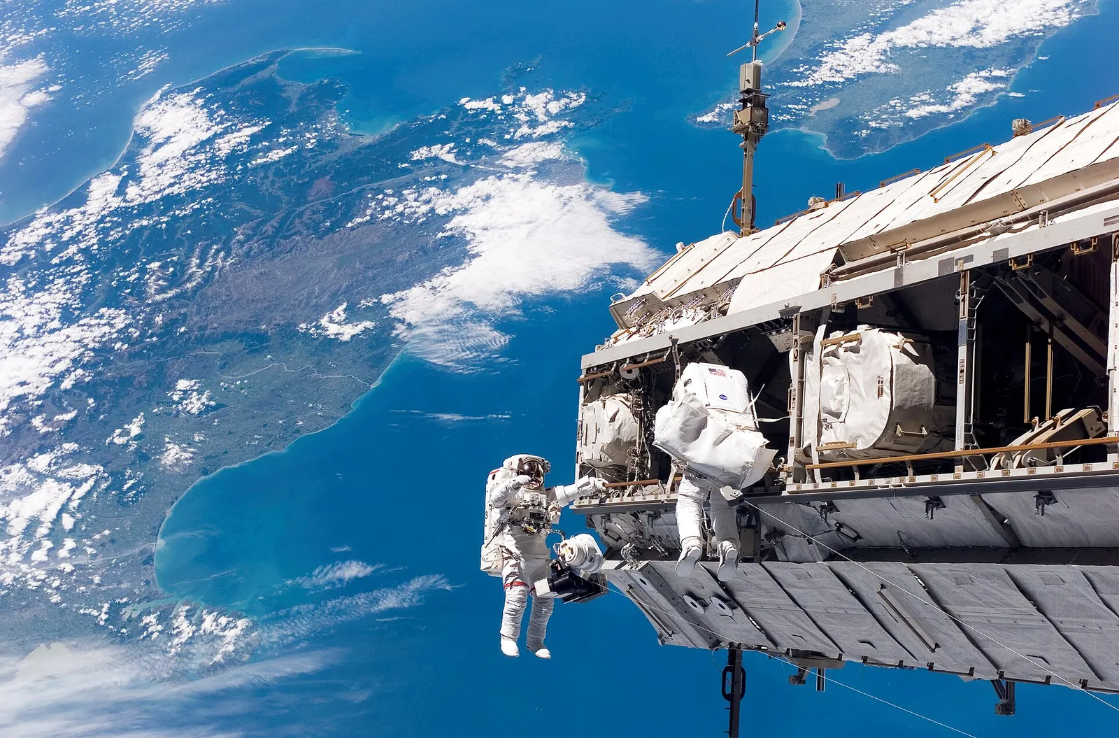 An astronaut works in orbit during a spacewalk