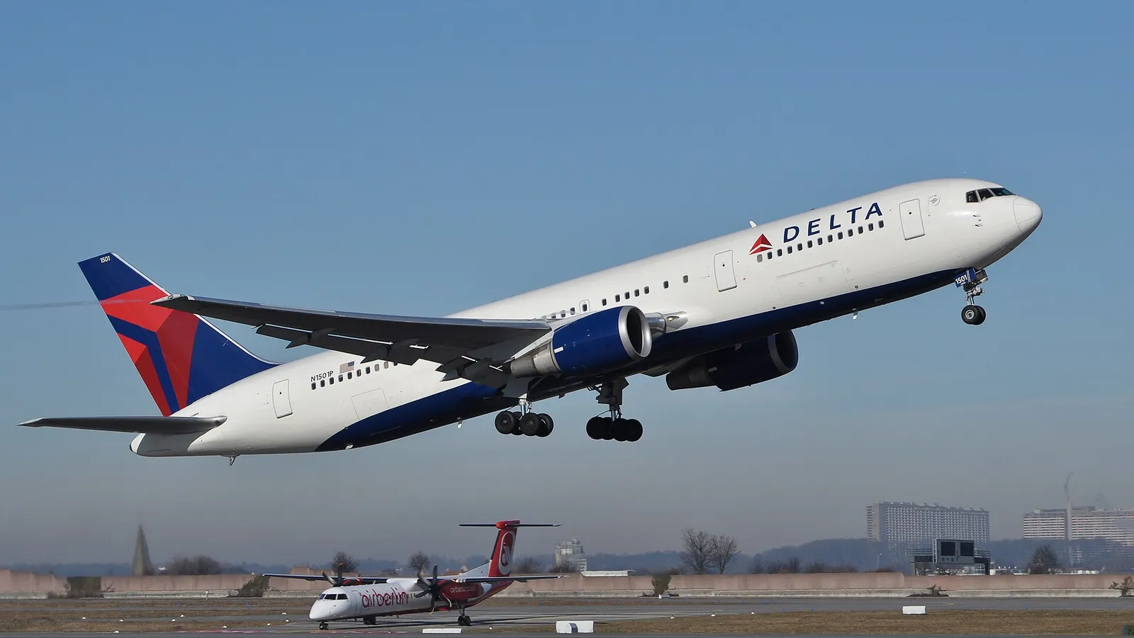 A Delta Air Lines Boeing 767 lifting off from a runway