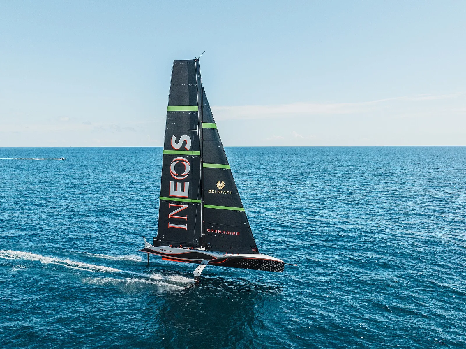 An AC75 America's Cup foiling yacht racing at speed