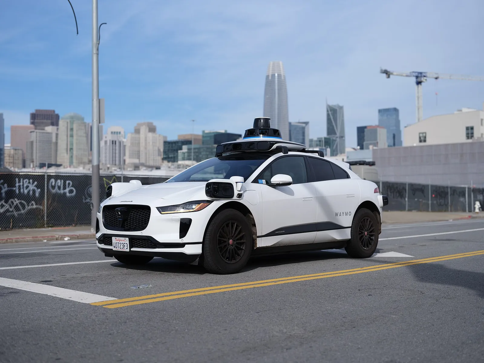 A Waymo Jaguar I-Pace driverless vehicle on a city street