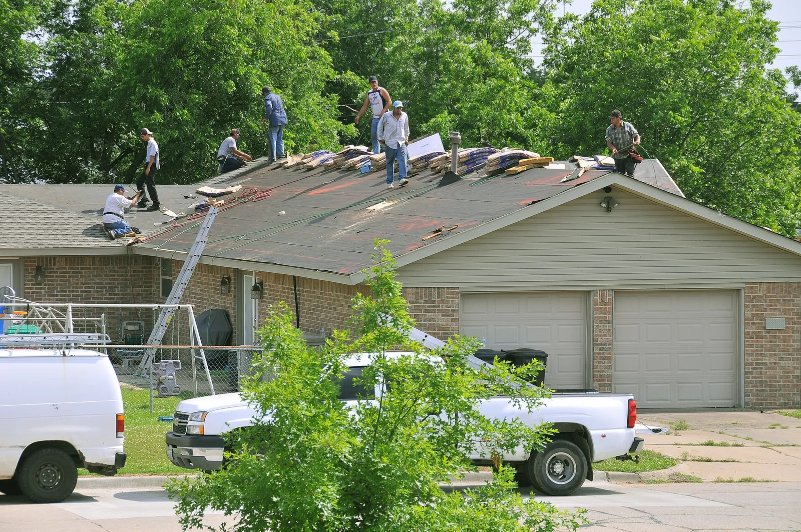 Workers repairing a residential roof