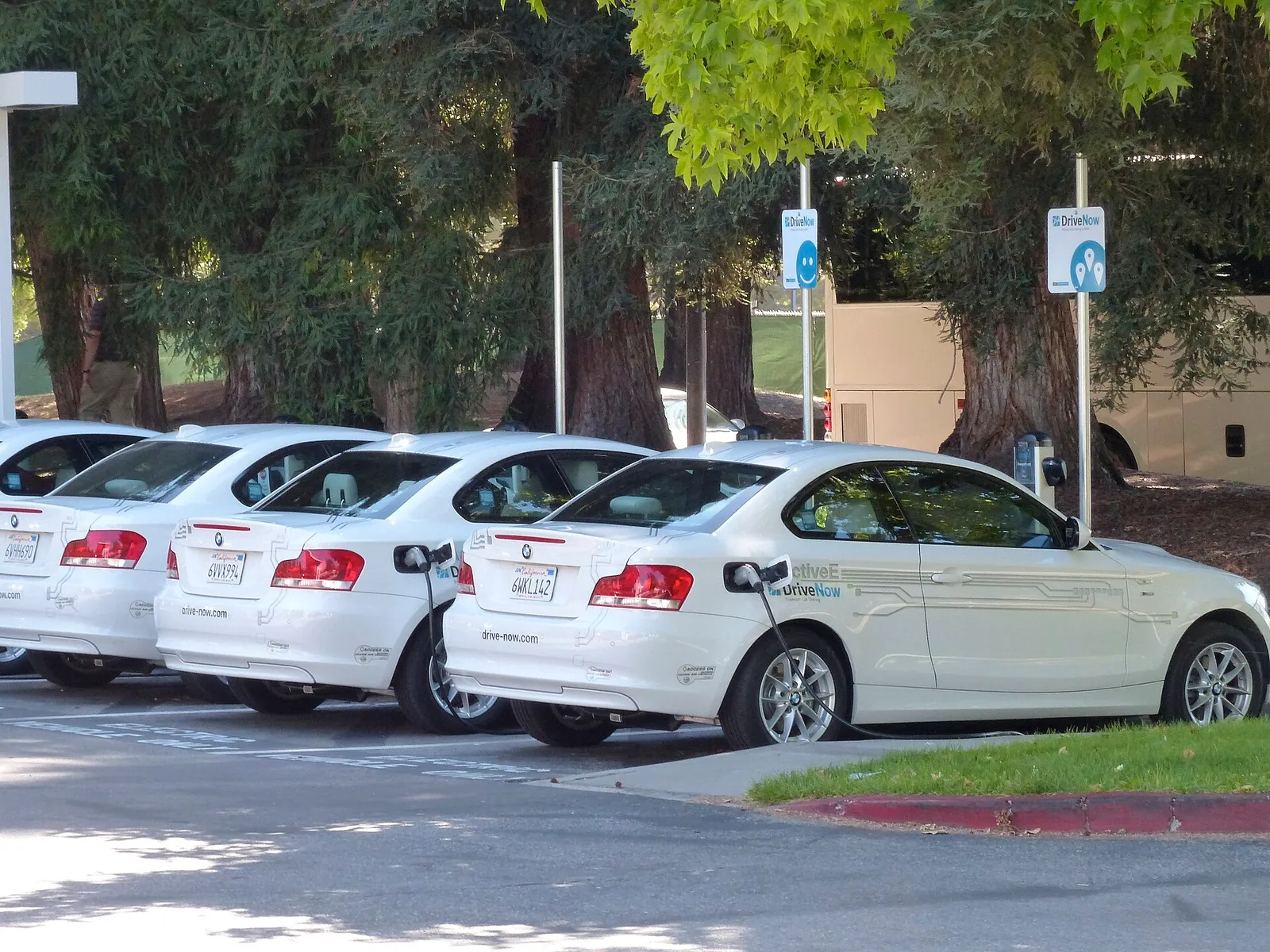 Electric BMW vehicles plugged in at charging stations