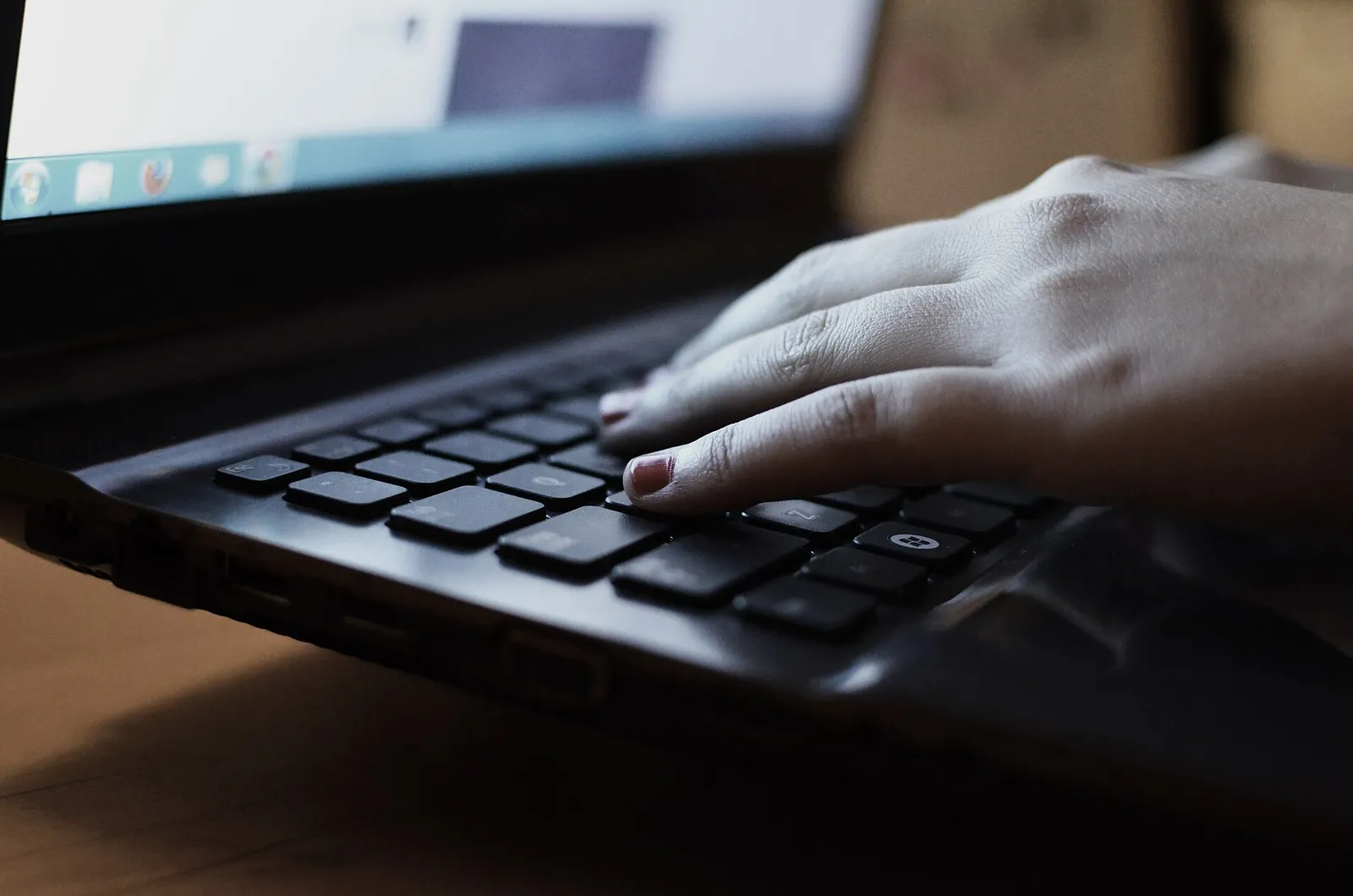 A person typing on a laptop