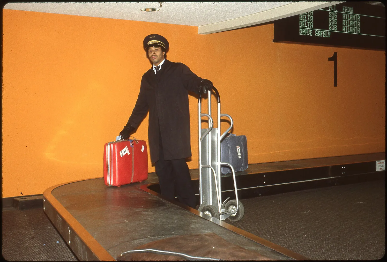 Travelers waiting at an airport baggage carousel