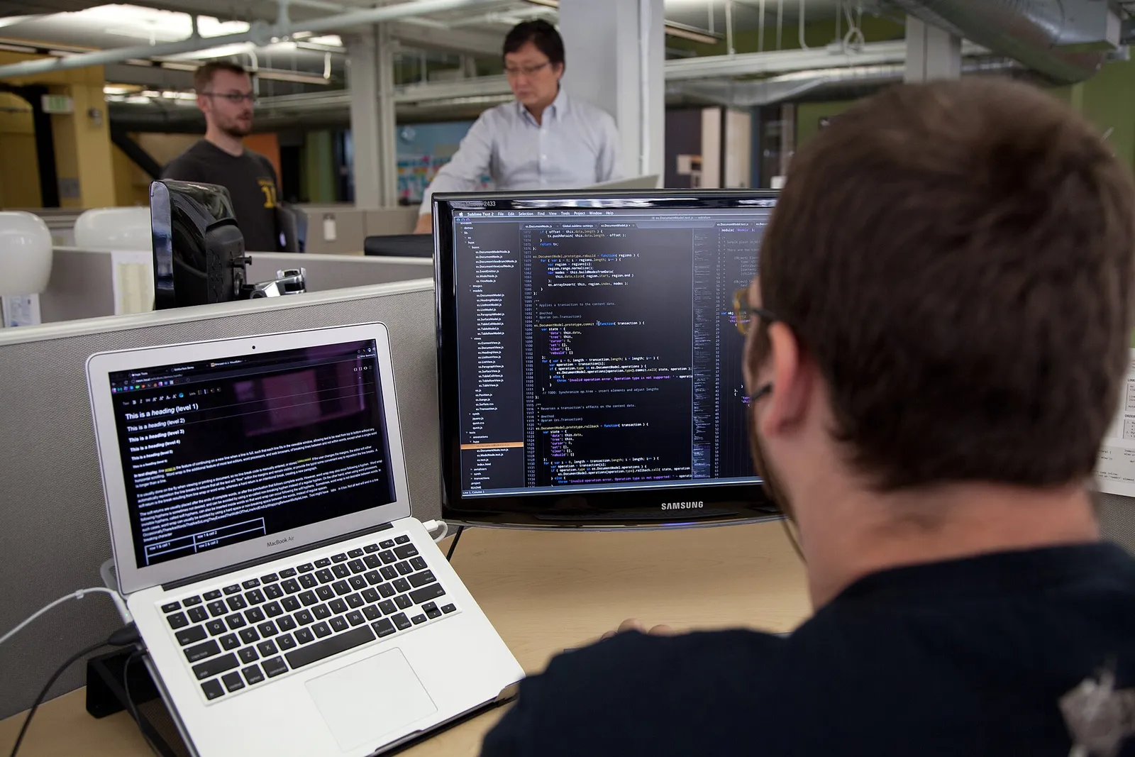 A developer writing code on a computer