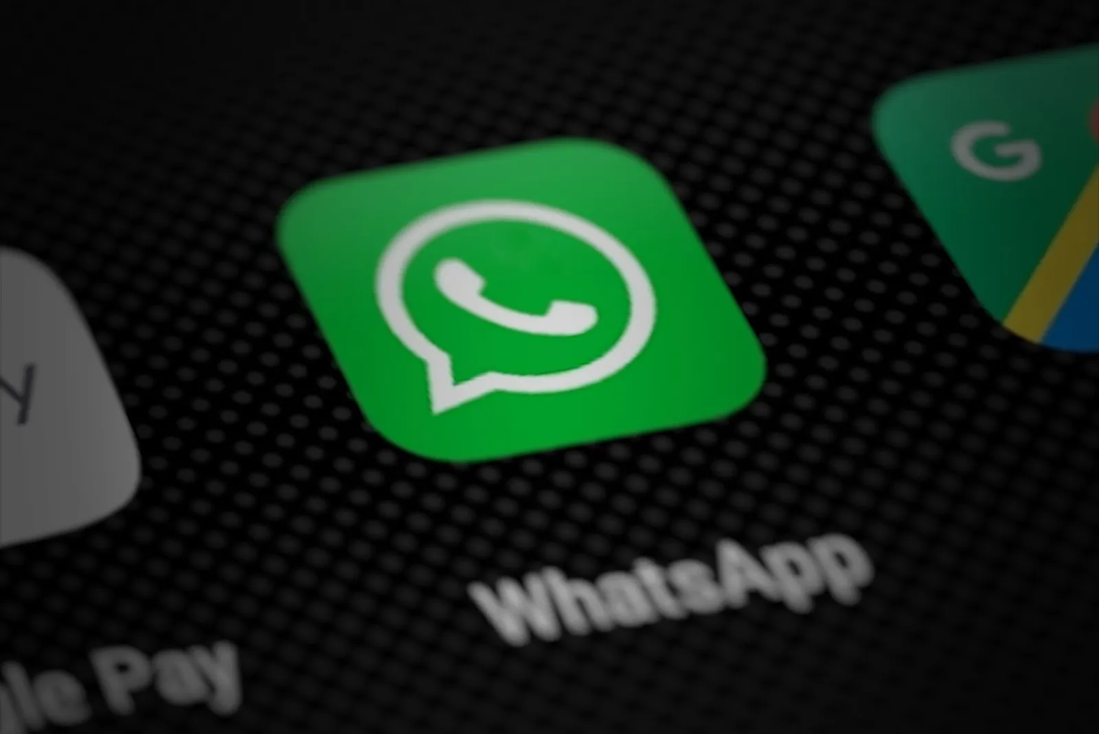 The WhatsApp app icon on a smartphone screen