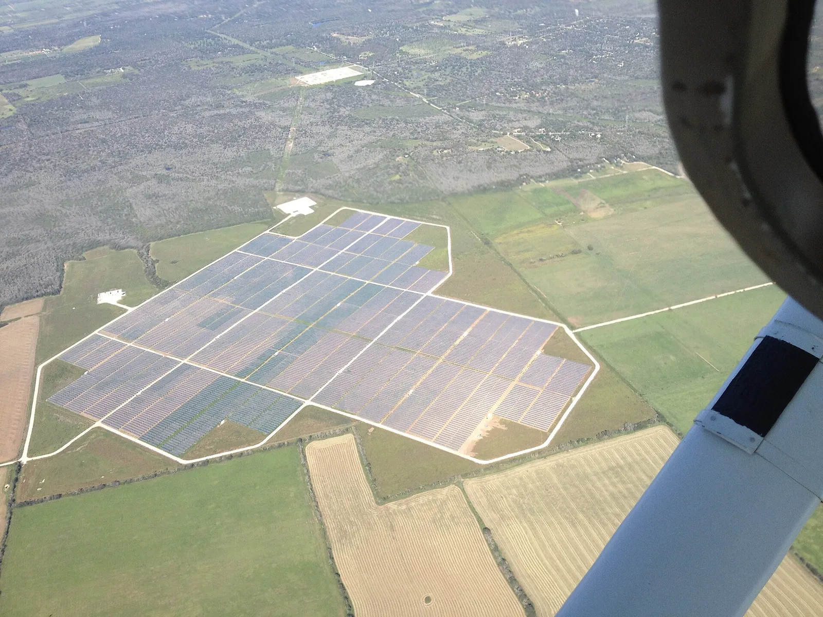An aerial view of rows of panels at a utility-scale solar farm