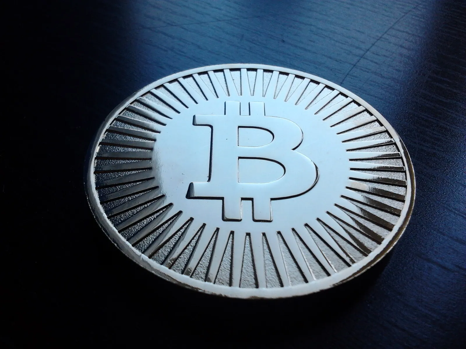 A physical novelty coin representing bitcoin